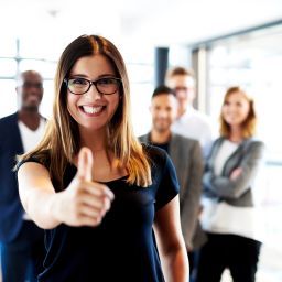 Professionals pausing together in an office (stretching, chatting, relaxing) to support mental health and wellbeing at work.