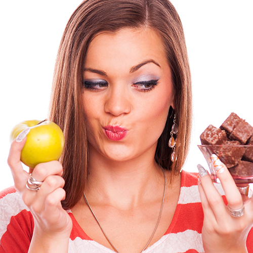 Young woman choosing unhealthy food