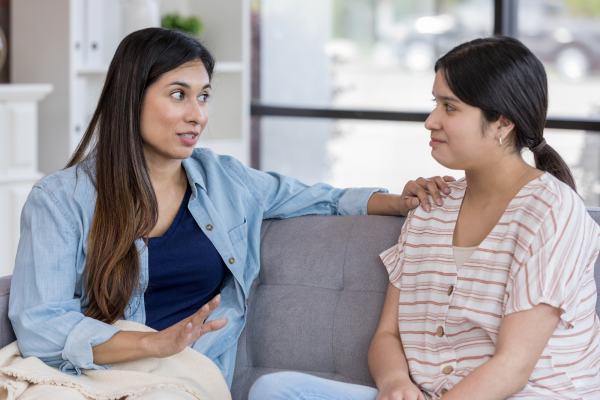 Two women talking to each other in a friendly way