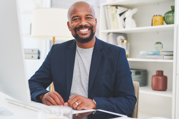Foundations of Wellbeing smiling man in casual office setting