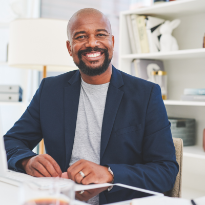 Foundations of Wellbeing smiling man in casual office setting